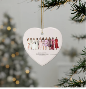 a heart shaped christmas ornament with a group of women in dresses